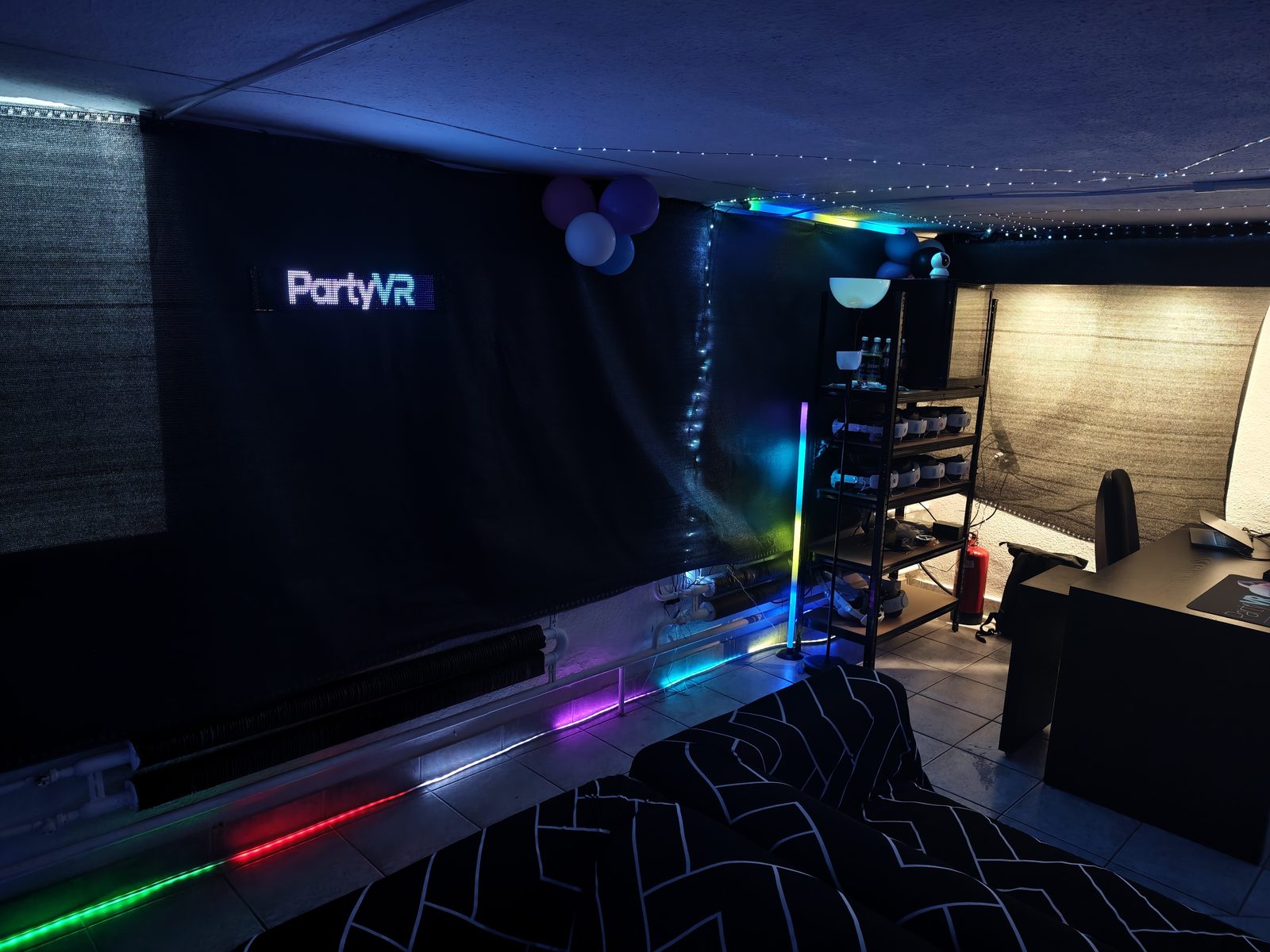 Meta Quest 3 VR headsets on the shelf with chargers and PartyVR LED sign